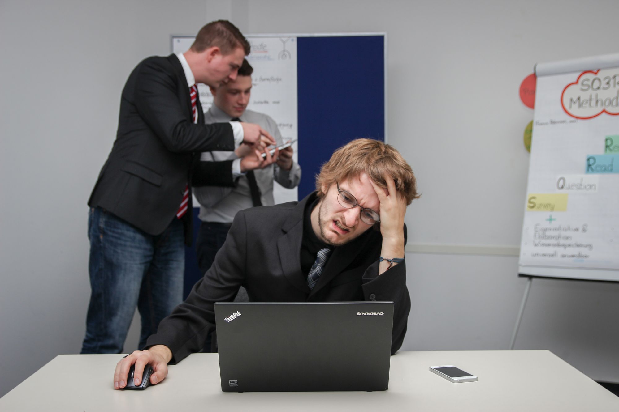 A man who is burntout stares frustratedly at his laptop